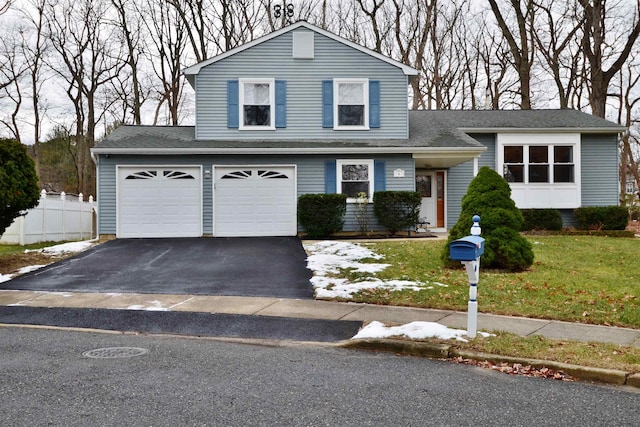 view of front of property featuring a garage and a front lawn