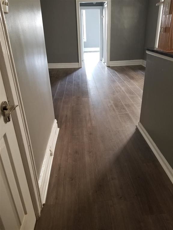 hallway with dark wood-type flooring