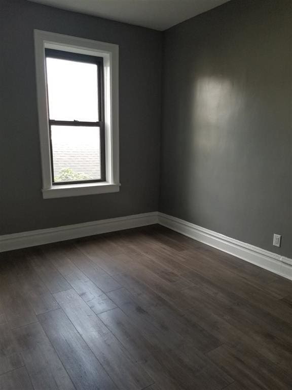 spare room with dark hardwood / wood-style floors