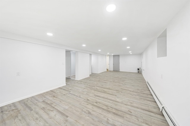 418 7th St, Union City, NJ 07087 - finished below grade area featuring recessed lighting, light wood-type flooring, and a baseboard heating unit