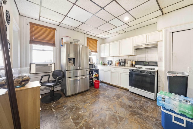 418 7th St, Union City, NJ 07087 - kitchen featuring stainless steel appliances, under cabinet range hood, white cabinets, cooling unit, and a paneled ceiling
