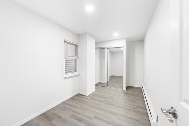 418 7th St, Union City, NJ 07087 - unfurnished bedroom with a baseboard radiator, recessed lighting, light wood finished floors, and a closet