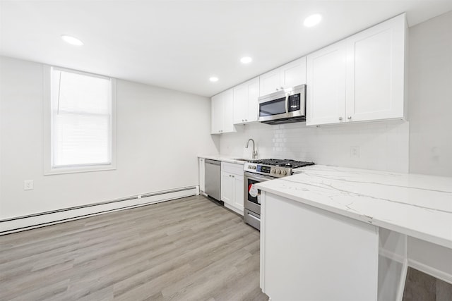 418 7th St, Union City, NJ 07087 - kitchen with stainless steel appliances, backsplash, white cabinetry, light stone countertops, and recessed lighting