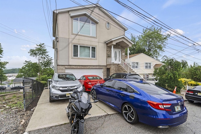 8901 Newkirk Ave, North Bergen, NJ 07047 - multi unit property featuring stucco siding, an attached garage, and concrete driveway