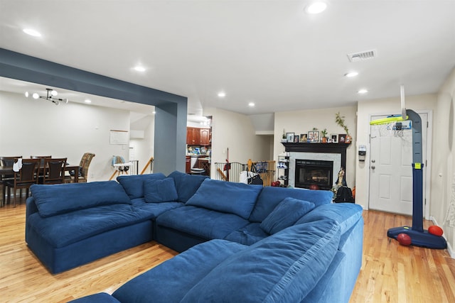 8901 Newkirk Ave, North Bergen, NJ 07047 - living room with light wood-style floors, recessed lighting, and a glass covered fireplace
