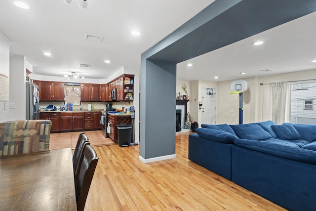 8901 Newkirk Ave, North Bergen, NJ 07047 - living room with light wood-style floors, a fireplace, and recessed lighting