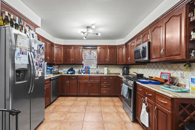 8901 Newkirk Ave, North Bergen, NJ 07047 - kitchen with appliances with stainless steel finishes, backsplash, light tile patterned flooring, and light stone countertops