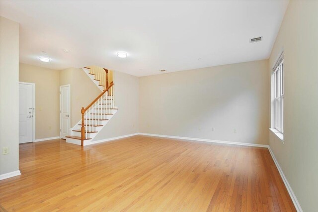 25 Duncan Ave Unit 210, Jersey City, NJ 07304 - empty room with light wood-type flooring and stairs