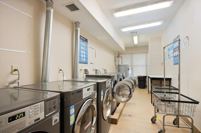 25 Duncan Ave Unit 210, Jersey City, NJ 07304 - laundry area featuring washer and dryer, water heater, and light tile patterned flooring