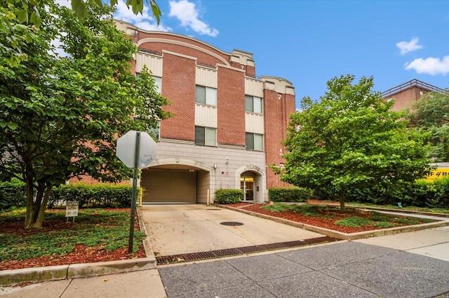 25 Duncan Ave Unit 210, Jersey City, NJ 07304 - view of front of home with concrete driveway and brick siding