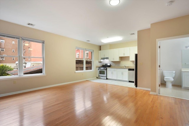 25 Duncan Ave Unit 210, Jersey City, NJ 07304 - unfurnished living room with light wood-style floors and baseboards