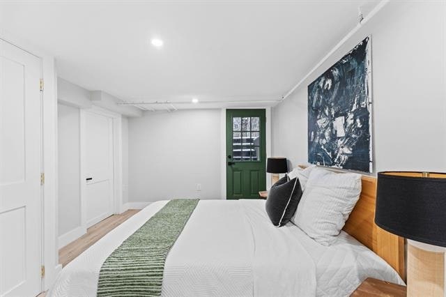 bedroom with wood finished floors and recessed lighting