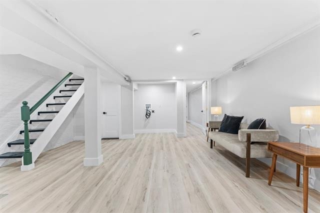 interior space with stairs, baseboards, and wood finished floors