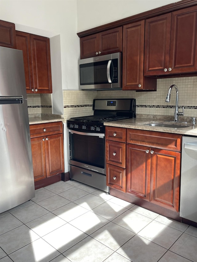 148 Nesbit St, Weehawken, NJ 07086 - kitchen with appliances with stainless steel finishes, decorative backsplash, and light tile patterned floors