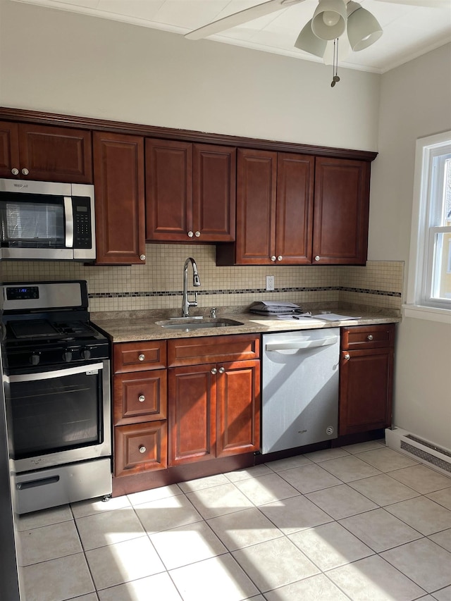 148 Nesbit St, Weehawken, NJ 07086 - kitchen with stainless steel appliances, tasteful backsplash, a ceiling fan, light tile patterned flooring, and reddish brown cabinets