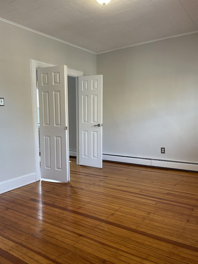 148 Nesbit St, Weehawken, NJ 07086 - spare room with baseboard heating, ornamental molding, and wood-type flooring