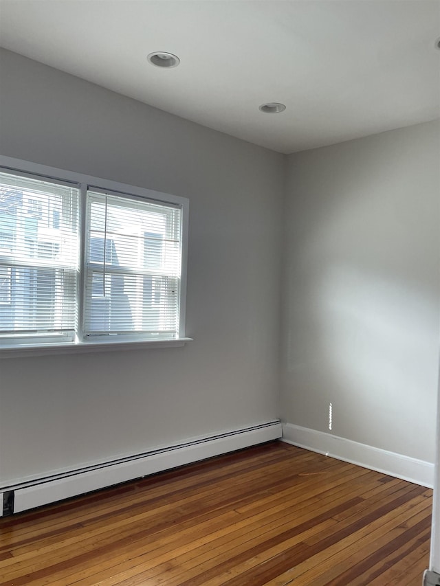 148 Nesbit St, Weehawken, NJ 07086 - spare room with baseboard heating, hardwood / wood-style floors, and recessed lighting