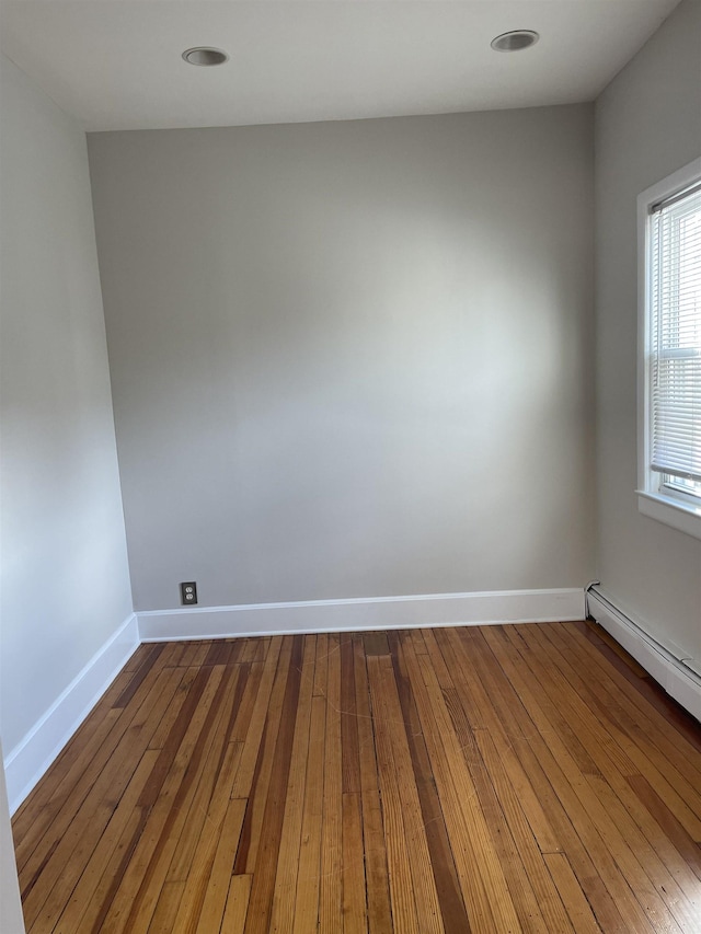 148 Nesbit St, Weehawken, NJ 07086 - unfurnished room featuring a baseboard heating unit and wood-type flooring