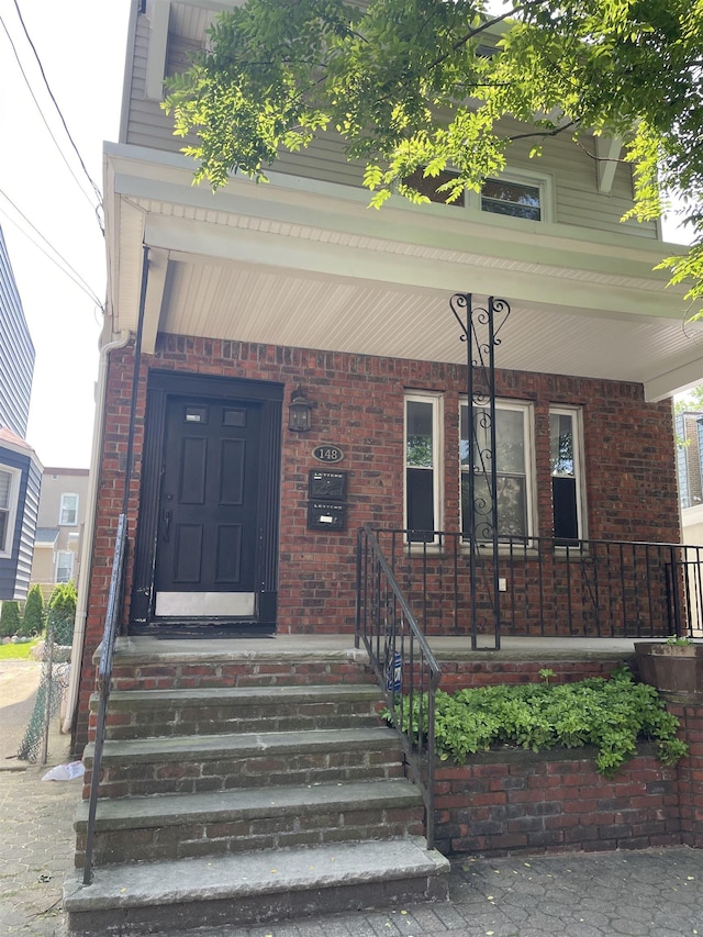 148 Nesbit St, Weehawken, NJ 07086 - property entrance with covered porch and brick siding