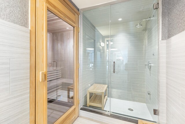 full bathroom with a sauna and a stall shower