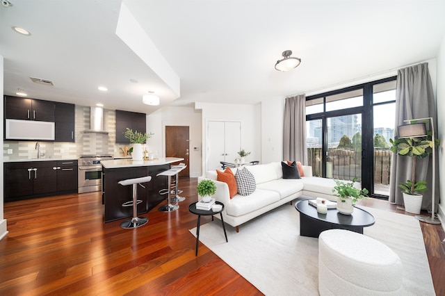 living room featuring recessed lighting, visible vents, and dark wood finished floors