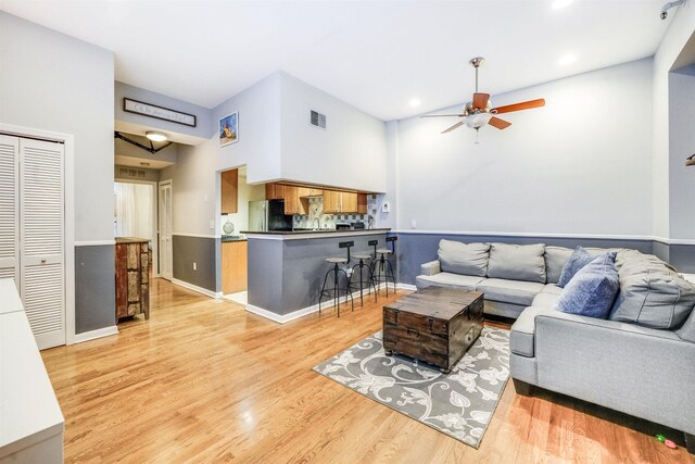 living room featuring ceiling fan and light wood-type flooring