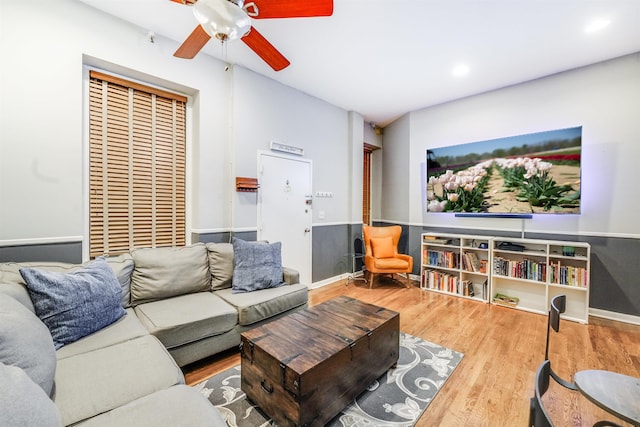 living room featuring hardwood / wood-style flooring and ceiling fan