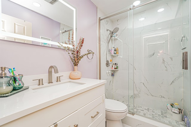bathroom featuring a marble finish shower, vanity, toilet, and marble finish floor