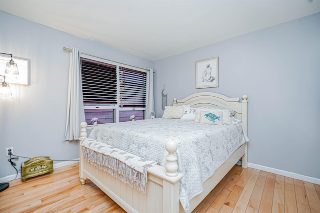 bedroom with baseboards and hardwood / wood-style floors