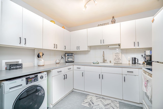 laundry area with washer / clothes dryer, laundry area, a sink, and marble finish floor