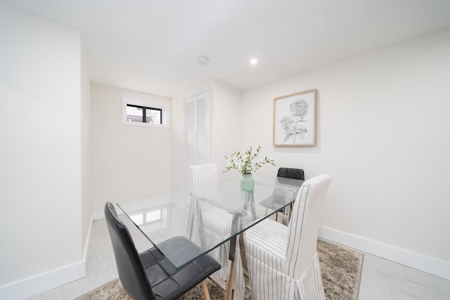 dining room with recessed lighting, wood finished floors, and baseboards