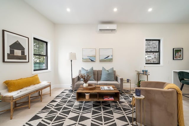 living area with baseboards, an AC wall unit, light wood-type flooring, and recessed lighting