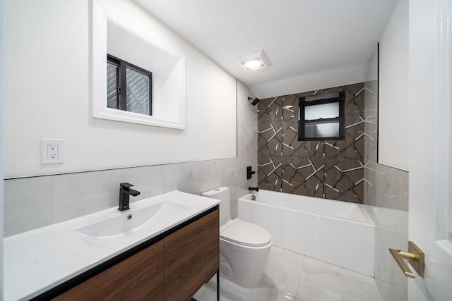 full bathroom with marble finish floor, tile walls, shower / bathing tub combination, toilet, and vanity