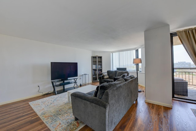 living room featuring baseboards and dark wood-style floors