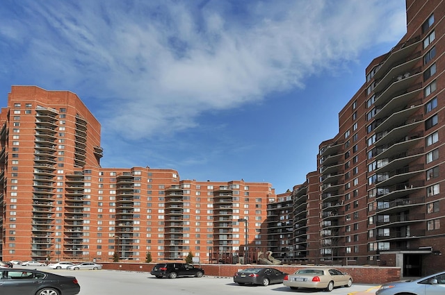 view of building exterior featuring uncovered parking