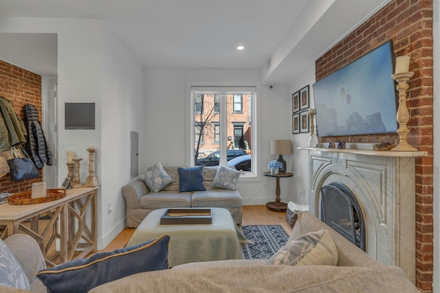157 8th St, Hoboken, NJ 07030 - living room with wood finished floors, brick wall, a fireplace, and recessed lighting