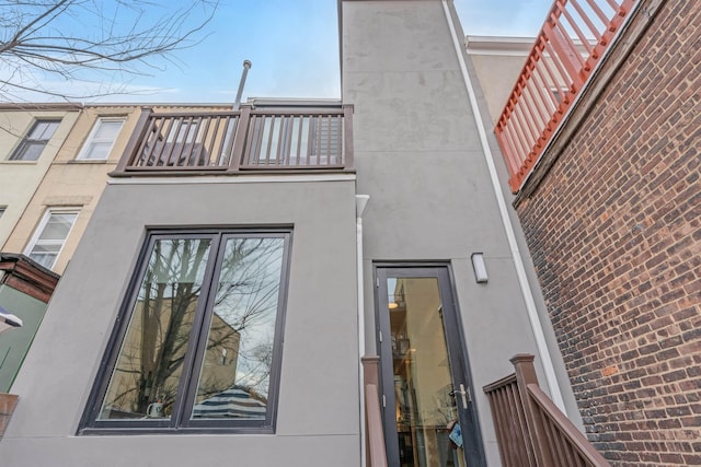 157 8th St, Hoboken, NJ 07030 - view of side of home with a balcony and stucco siding