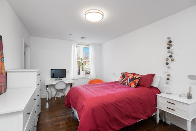 bedroom with dark wood-type flooring