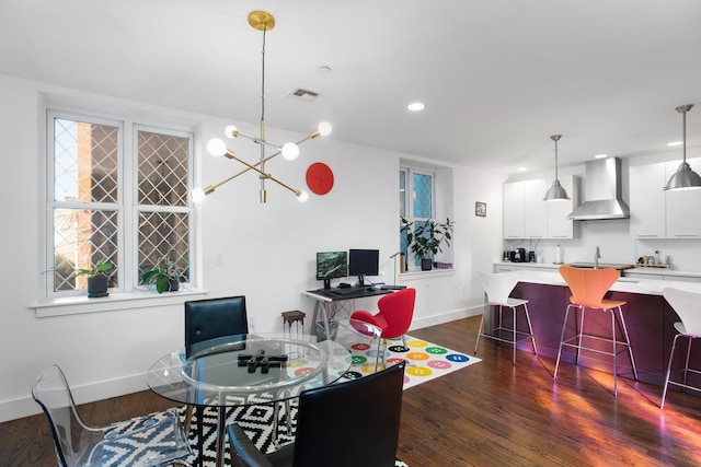 dining room featuring a notable chandelier and dark hardwood / wood-style floors