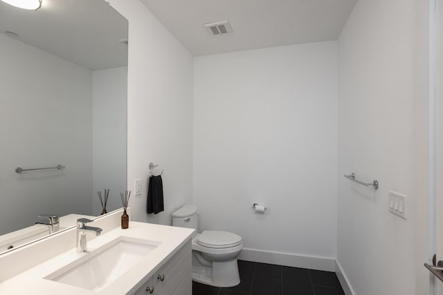 bathroom featuring toilet, tile patterned flooring, and vanity