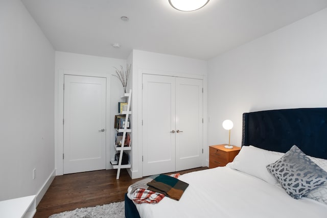 bedroom featuring a closet and dark hardwood / wood-style flooring