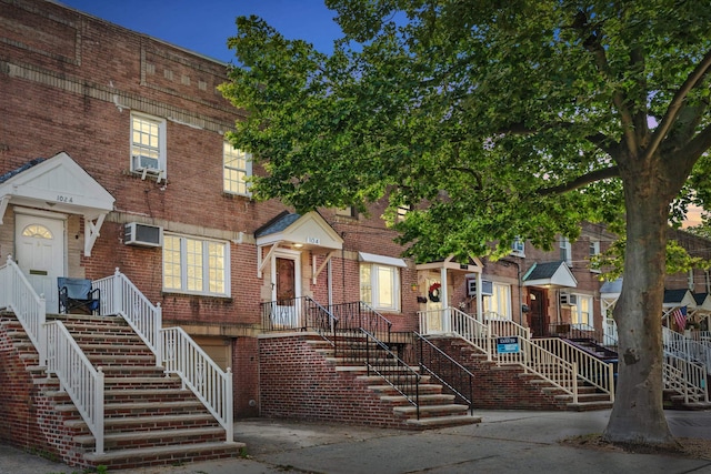 104 W 52nd St, Bayonne, NJ 07002 - townhome / multi-family property featuring a wall mounted air conditioner, an attached garage, and brick siding