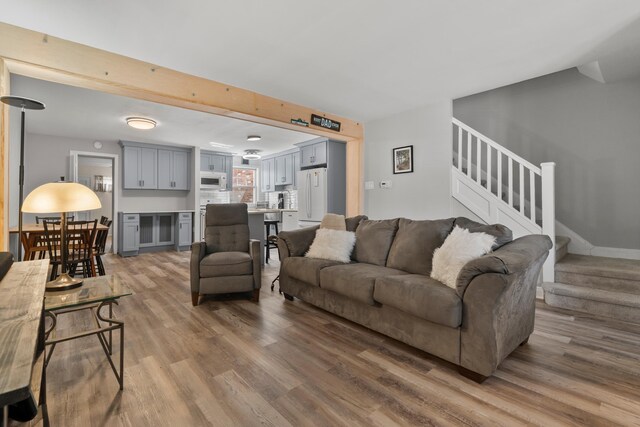 104 W 52nd St, Bayonne, NJ 07002 - living area with wood finished floors and stairway