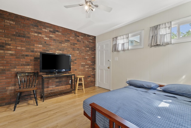 104 W 52nd St, Bayonne, NJ 07002 - bedroom with light wood-style floors, ceiling fan, and brick wall
