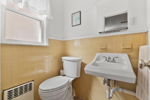 104 W 52nd St, Bayonne, NJ 07002 - half bathroom with tile walls, radiator, and a wainscoted wall