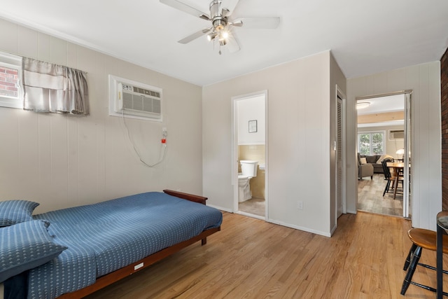 104 W 52nd St, Bayonne, NJ 07002 - bedroom featuring a wall mounted AC, light wood finished floors, a closet, and connected bathroom