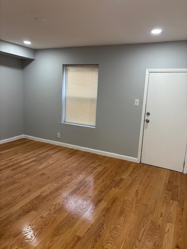 unfurnished room featuring recessed lighting, baseboards, and wood finished floors