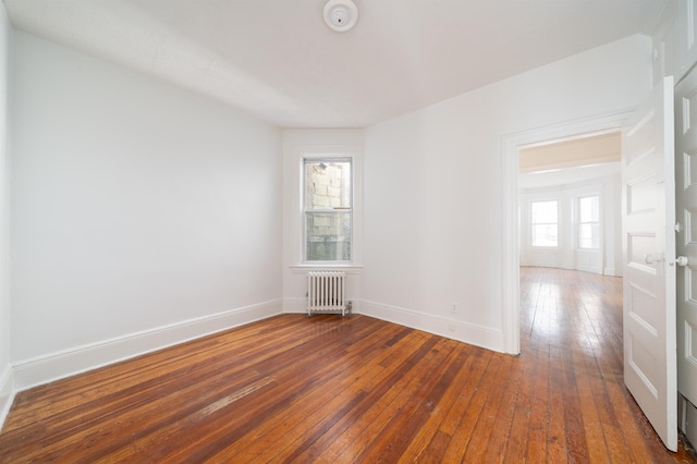 27 48th St, Weehawken, NJ 07086 - unfurnished room featuring radiator, a smoke detector, and hardwood / wood-style flooring