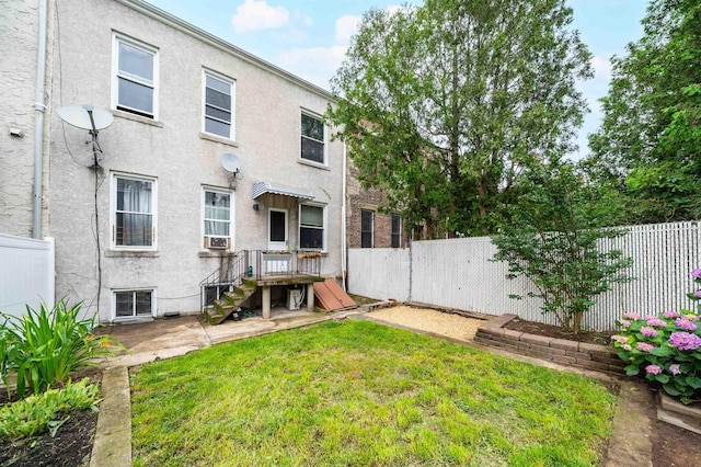 27 48th St, Weehawken, NJ 07086 - rear view of house with stucco siding and a patio area