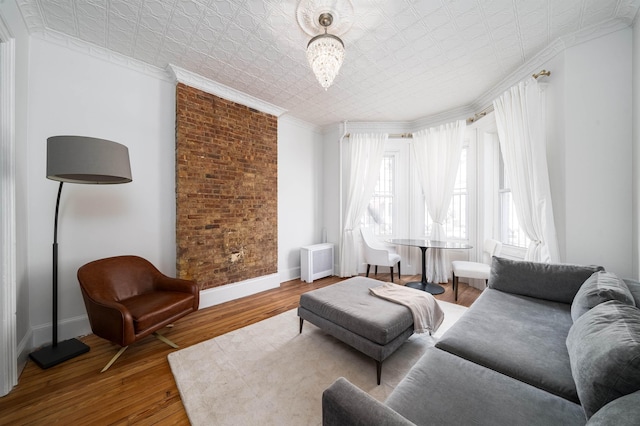 27 48th St, Weehawken, NJ 07086 - living room featuring an ornate ceiling, ornamental molding, radiator heating unit, and wood finished floors